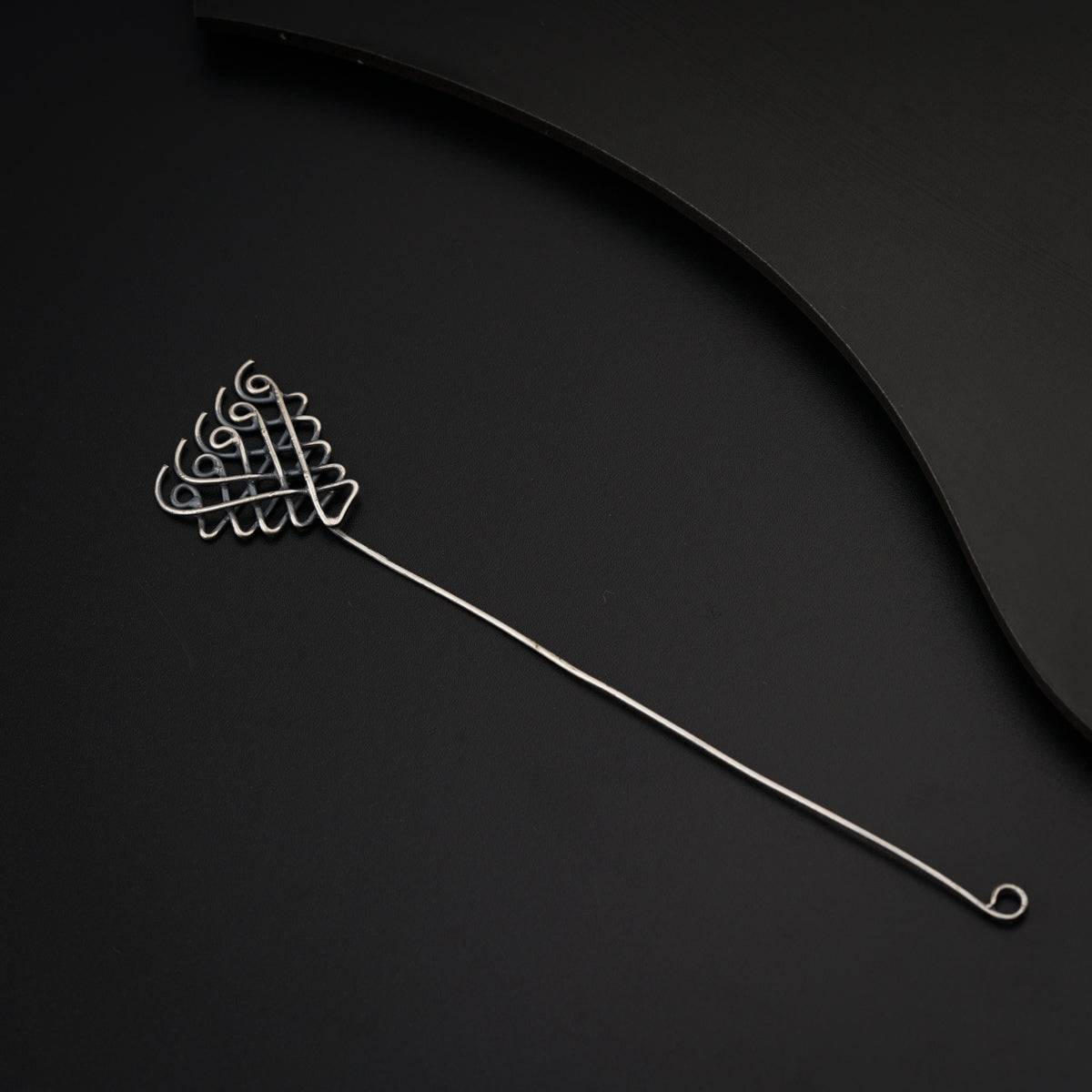a close up of a hair comb on a black surface