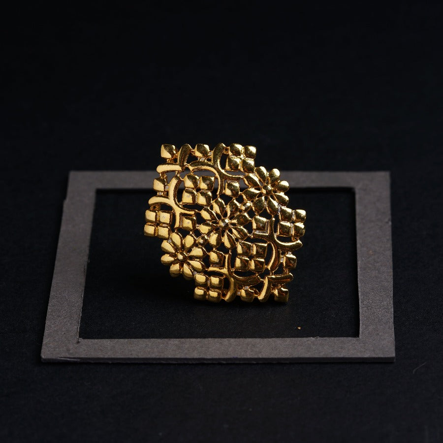 a gold ring sitting on top of a black surface