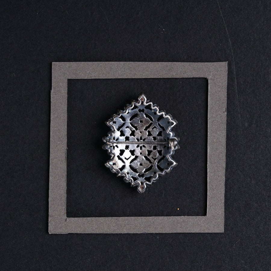 a metal object sitting on top of a black surface