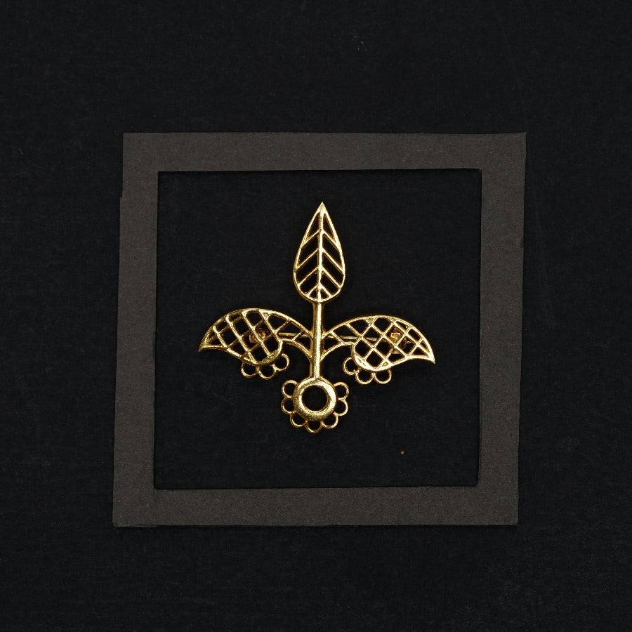 a picture of a gold fleur de lis brooch