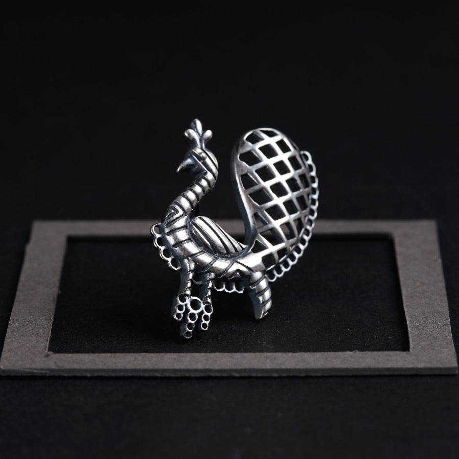 a metal object sitting on top of a black surface