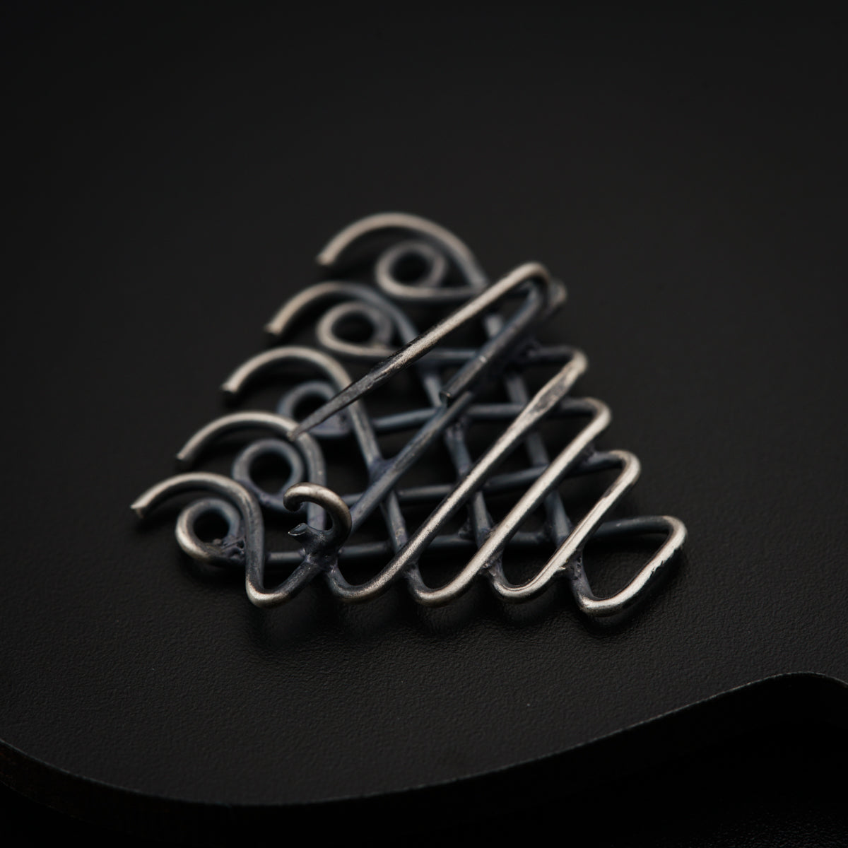 a close up of a metal object on a black surface