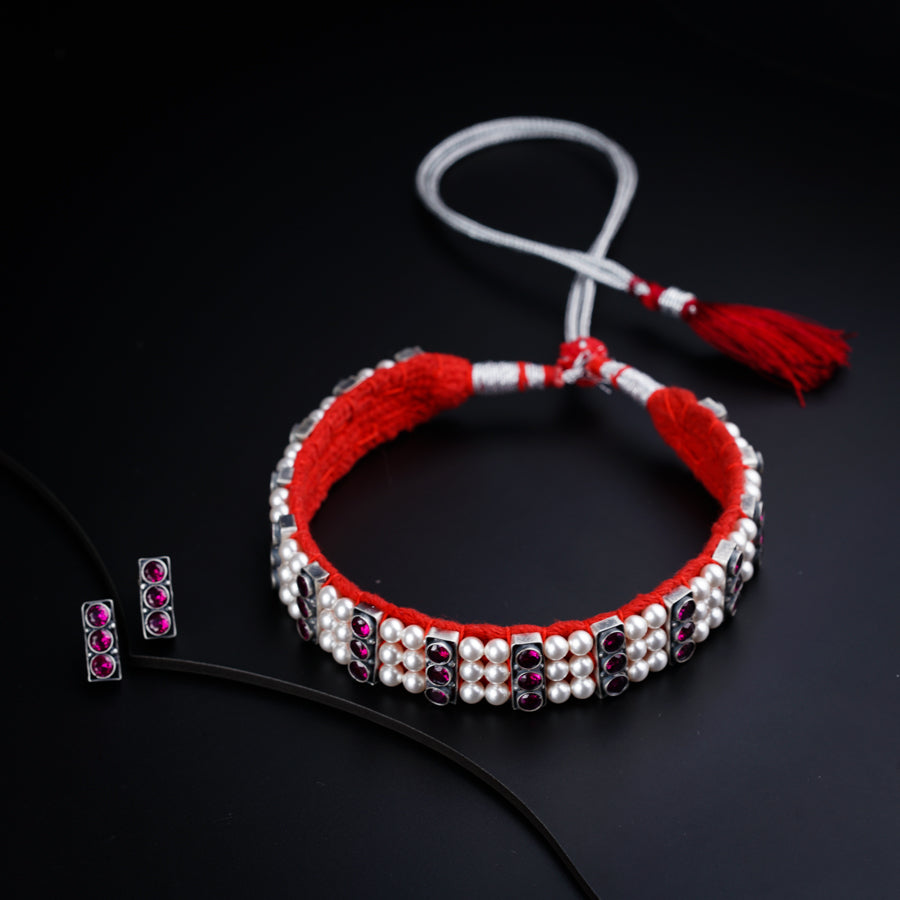 a pair of red and white beaded bracelets