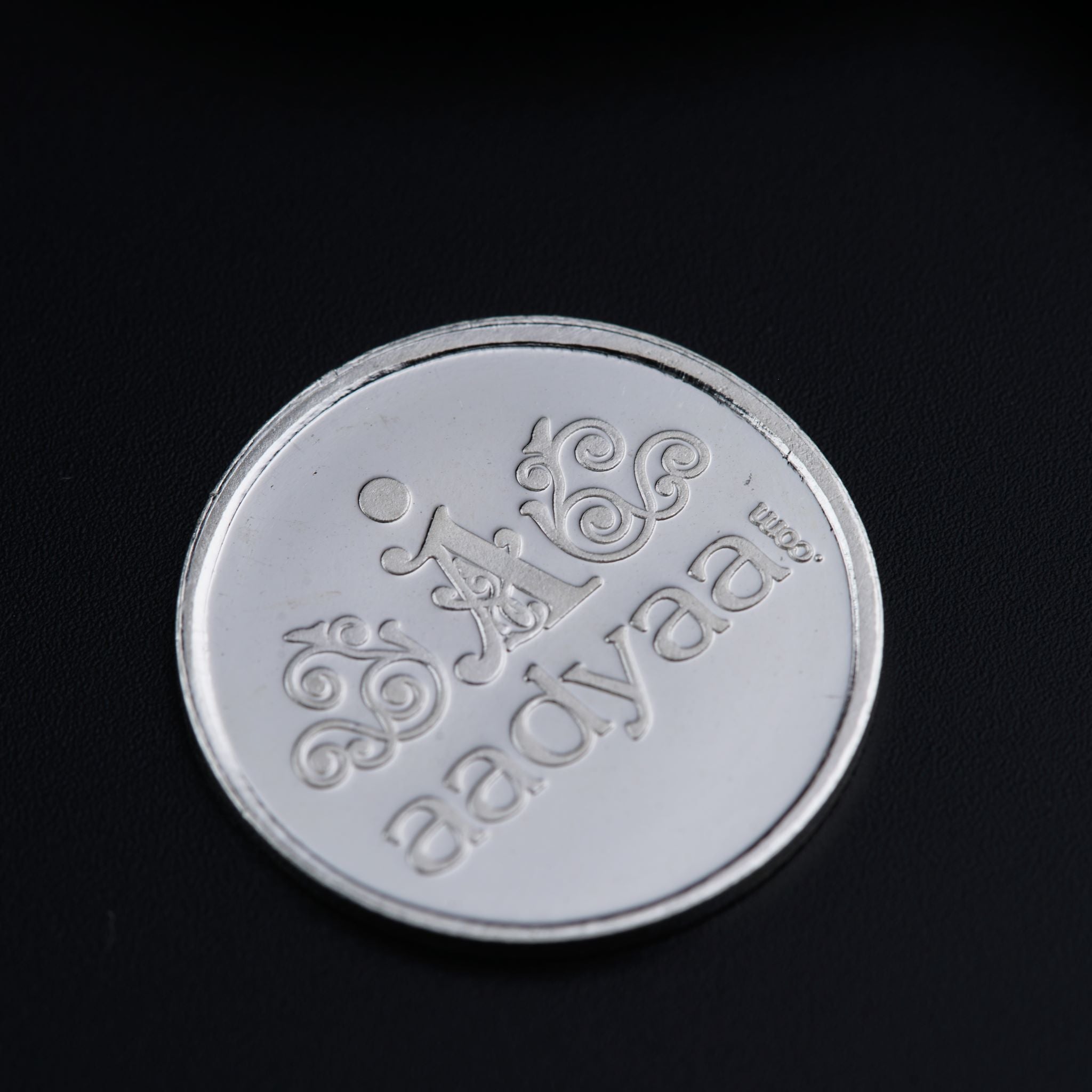 a close up of a coin on a black surface
