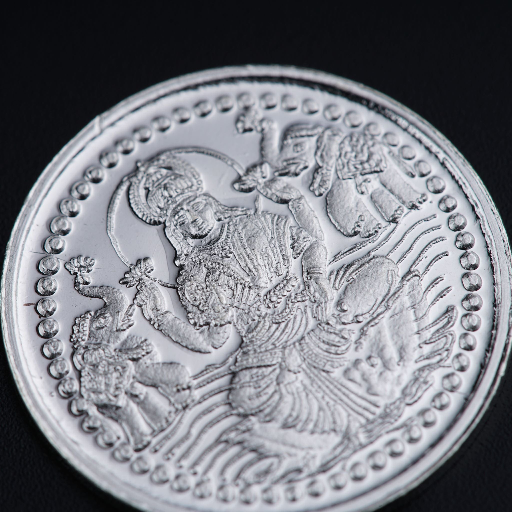 a silver coin with an image of a woman on it