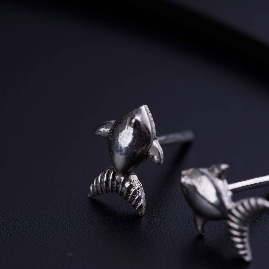 a pair of earrings sitting on top of a table