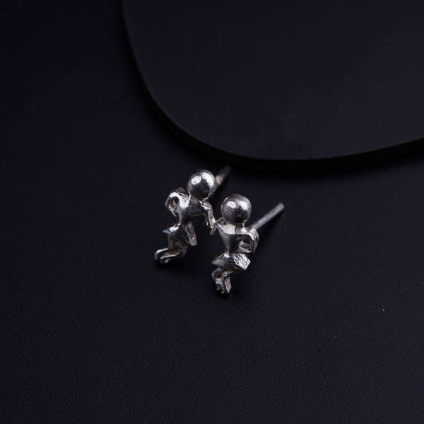 a pair of silver balls on a black surface