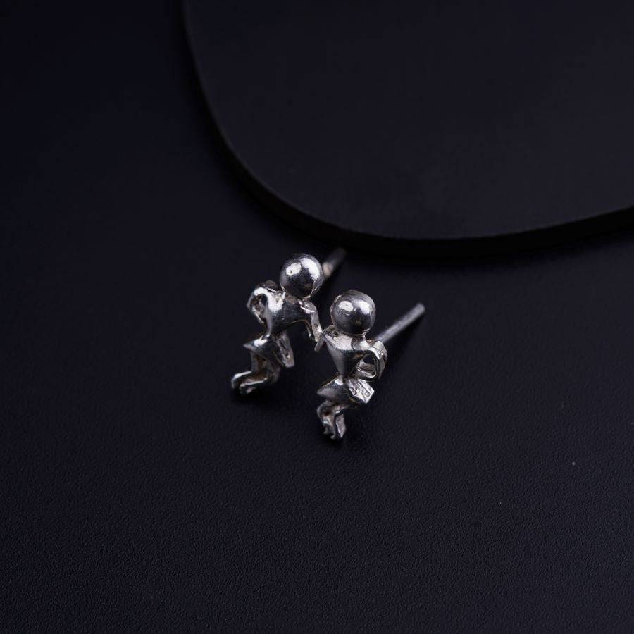 a pair of silver balls on a black surface