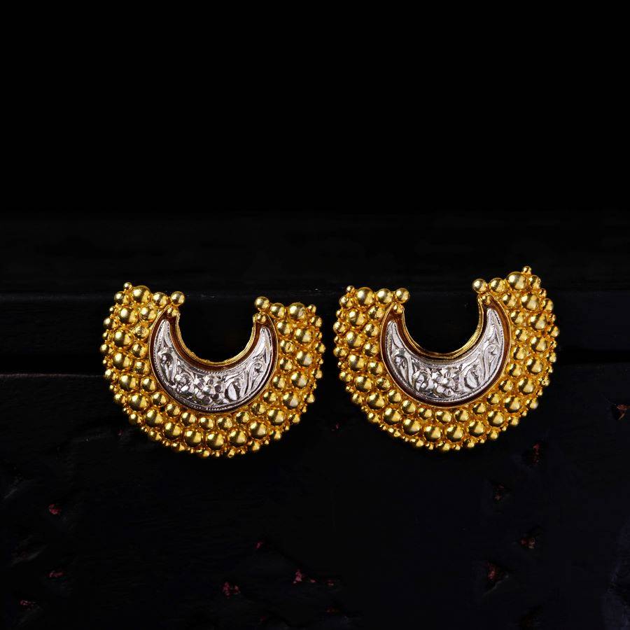 a pair of gold and silver earrings