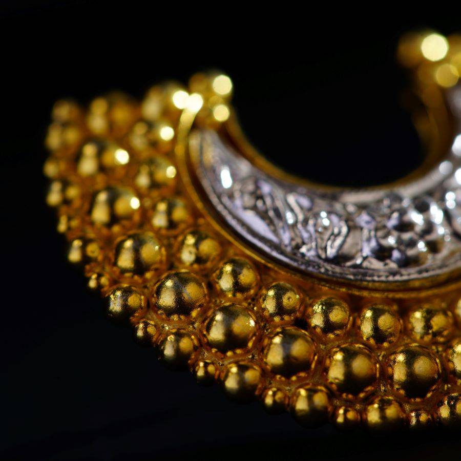 a close up of a gold and silver necklace