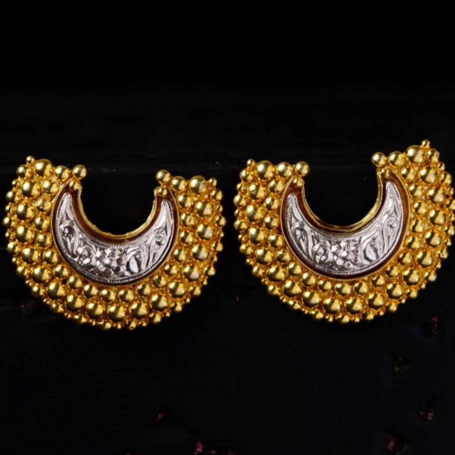 a pair of gold and silver earrings