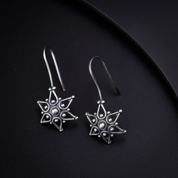 a pair of earrings sitting on top of a table