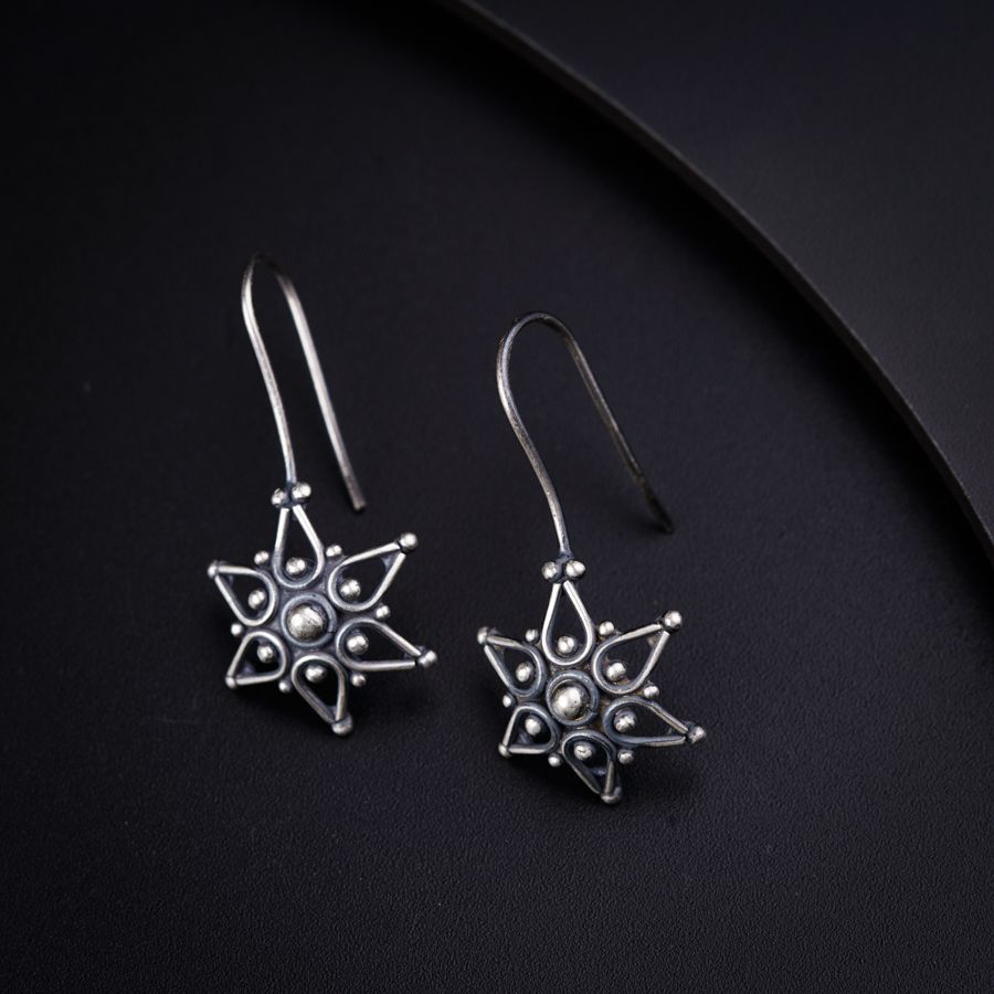 a pair of earrings sitting on top of a table