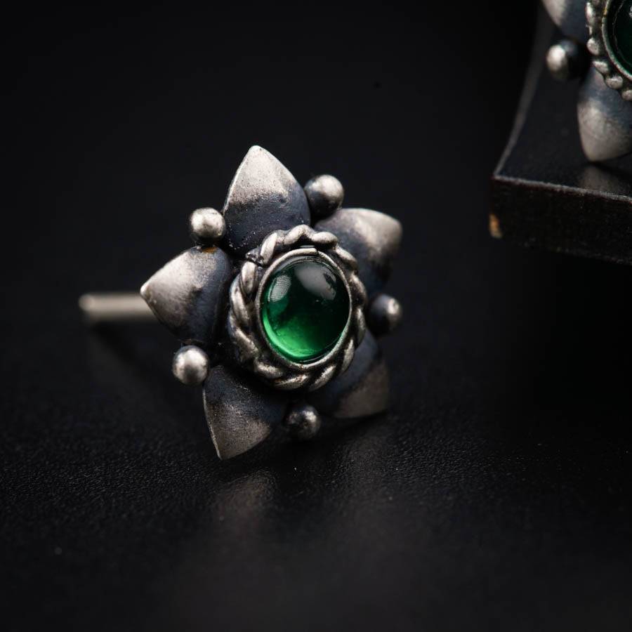 a close up of a pair of earrings on a table