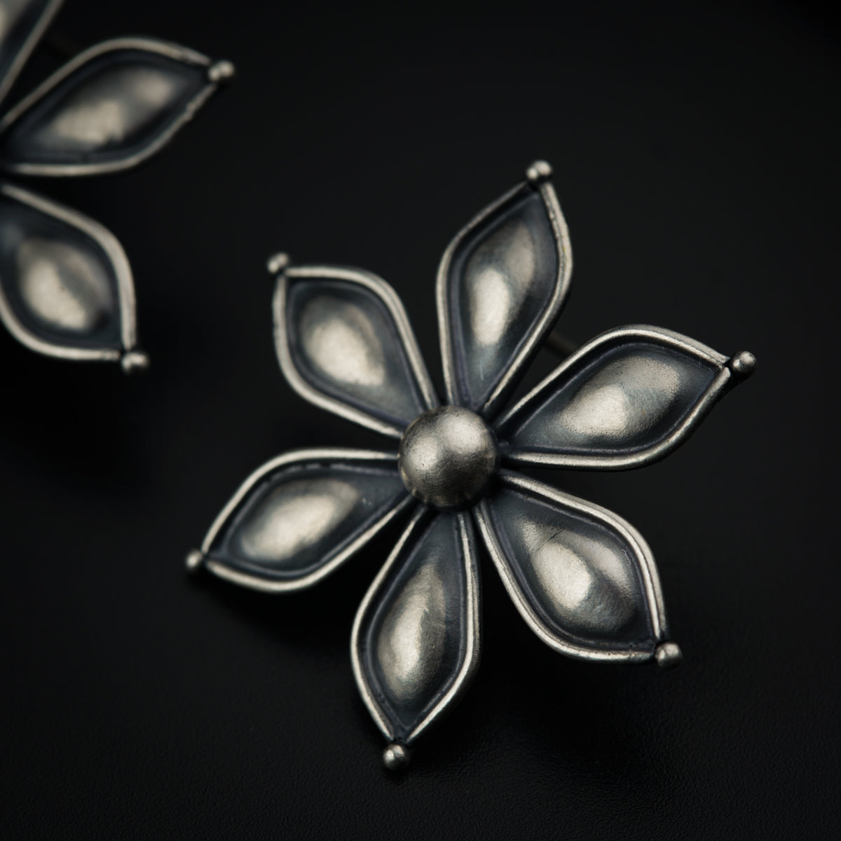 a close up of a metal object on a black surface