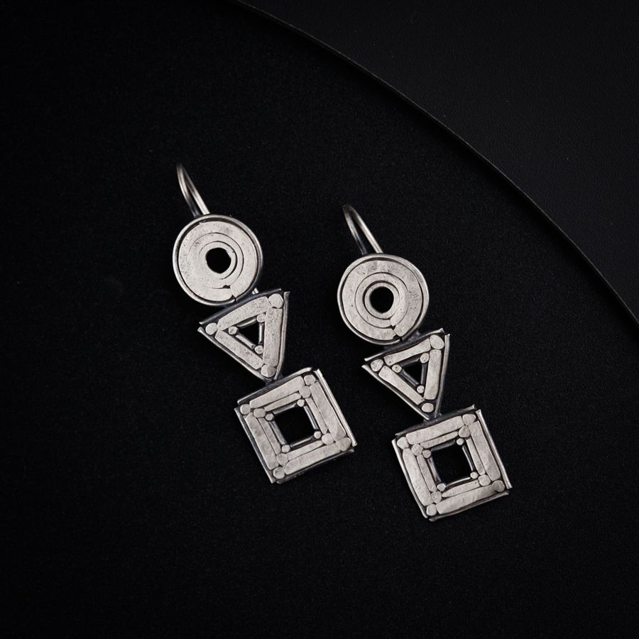 a pair of earrings sitting on top of a table