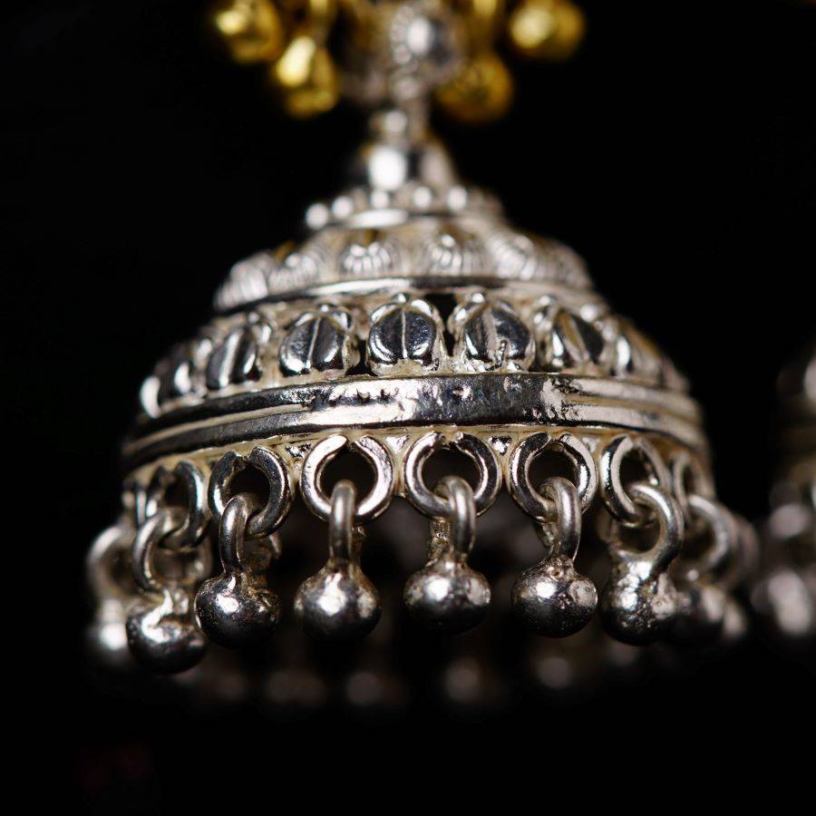 a close up of a metal object on a black background