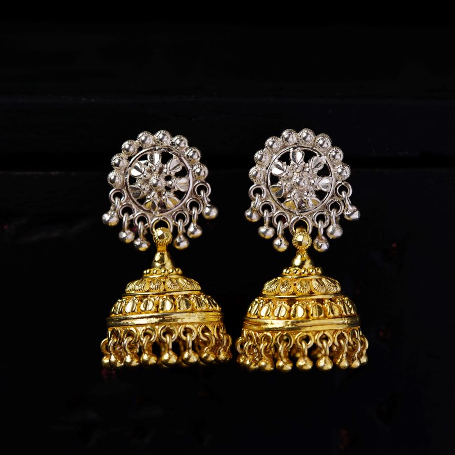 a pair of gold and diamond earrings