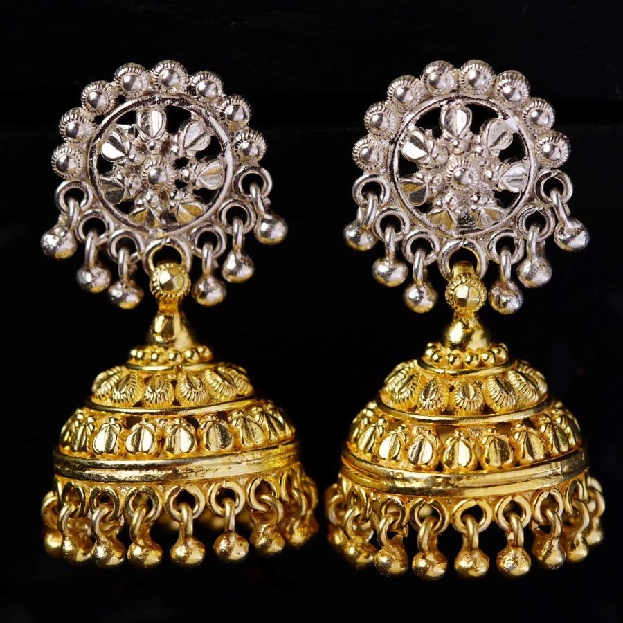 a pair of gold and silver earrings