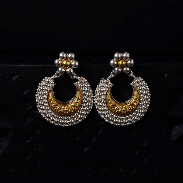 a pair of gold and silver earrings
