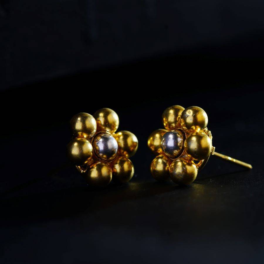 a pair of gold and pearl earrings