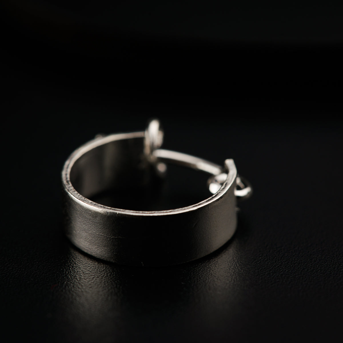 a close up of a ring on a black surface