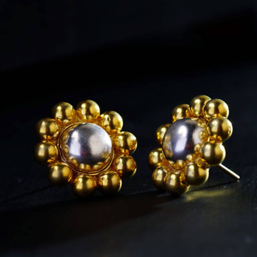 a pair of gold and pearl earrings