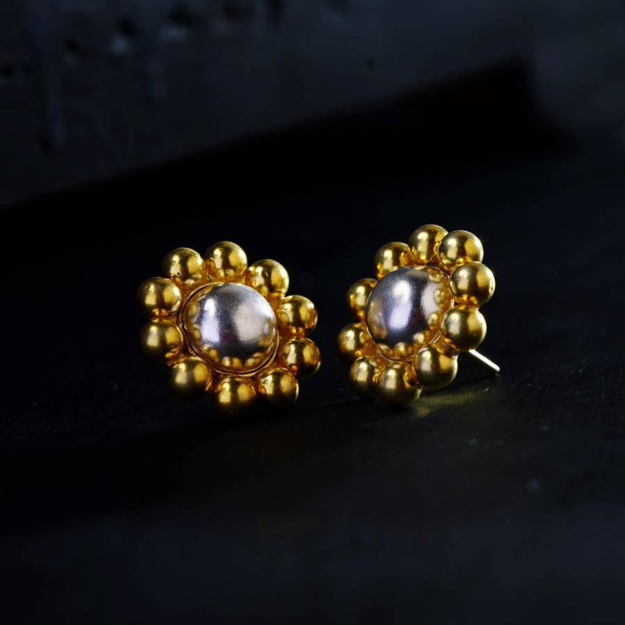 a pair of gold and pearl earrings