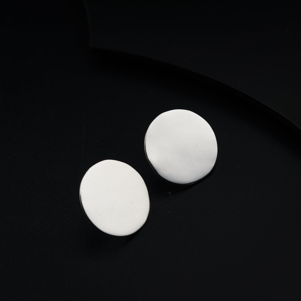 two white circles sitting on top of a black surface