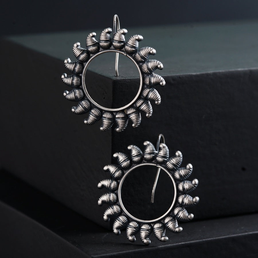 a pair of earrings sitting on top of a table