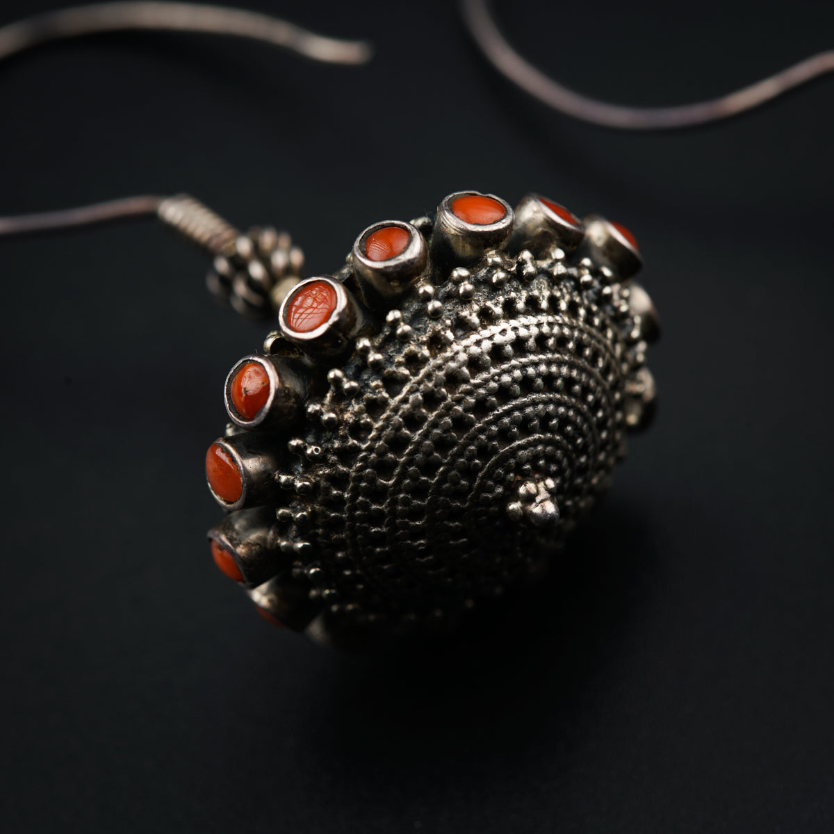 a close up of a metal object on a black surface