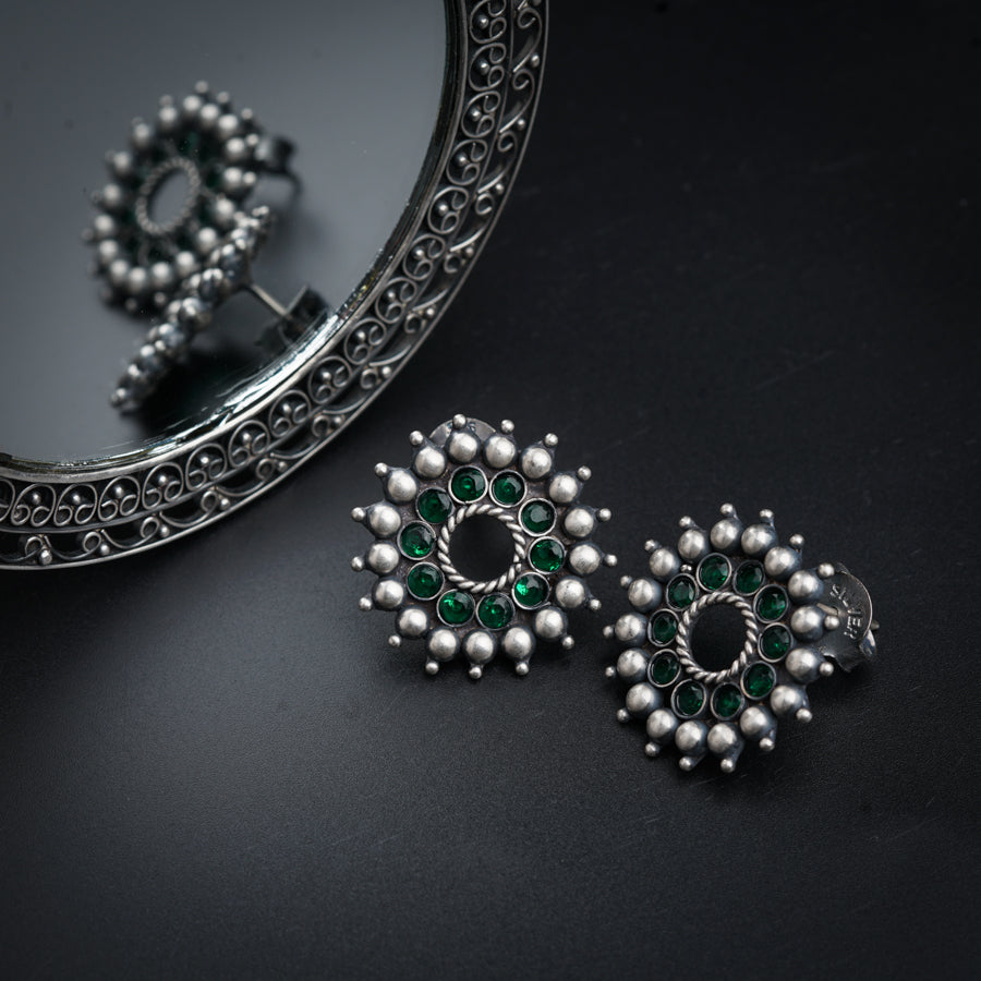 a pair of earrings sitting on top of a table