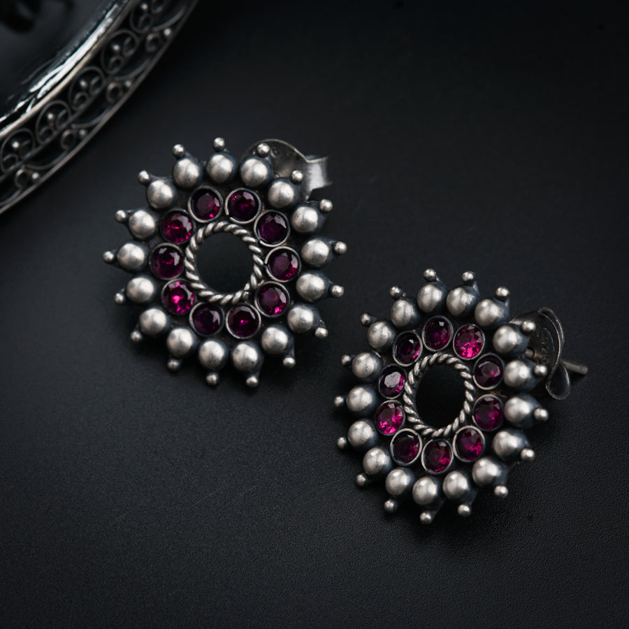 a pair of earrings sitting on top of a table