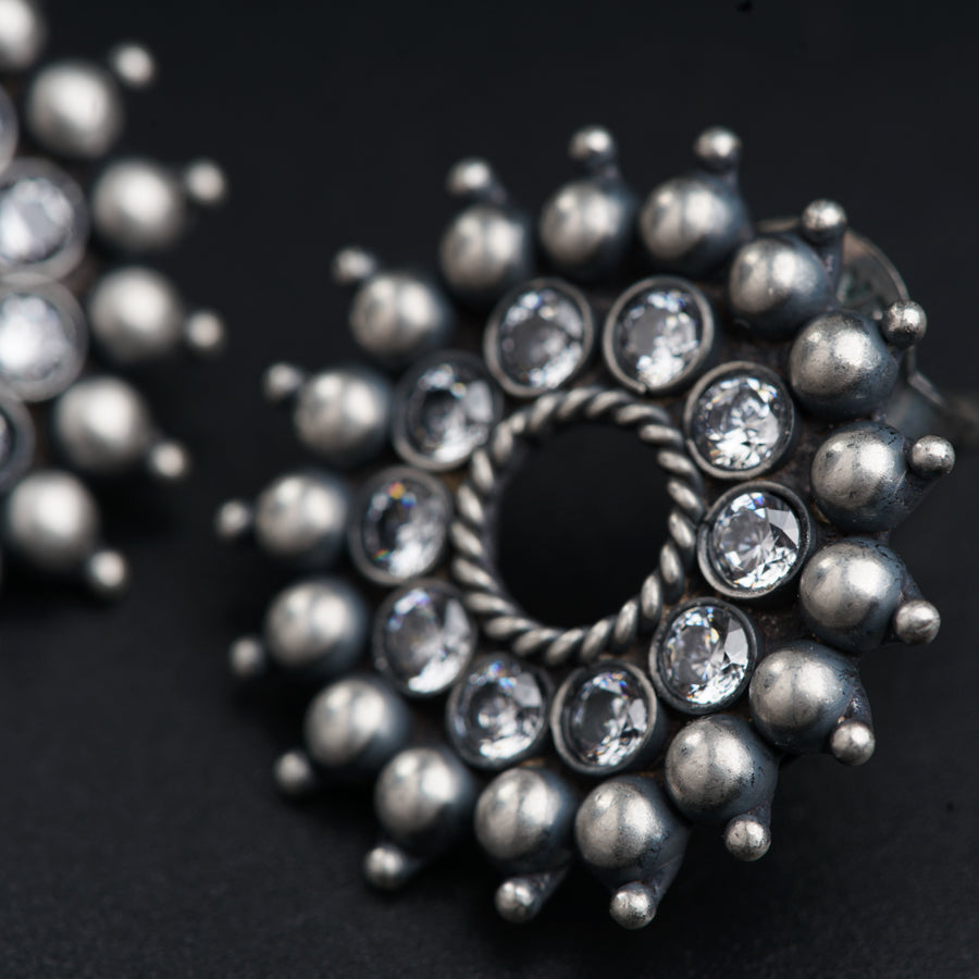 a close up of a ring and a pair of earrings