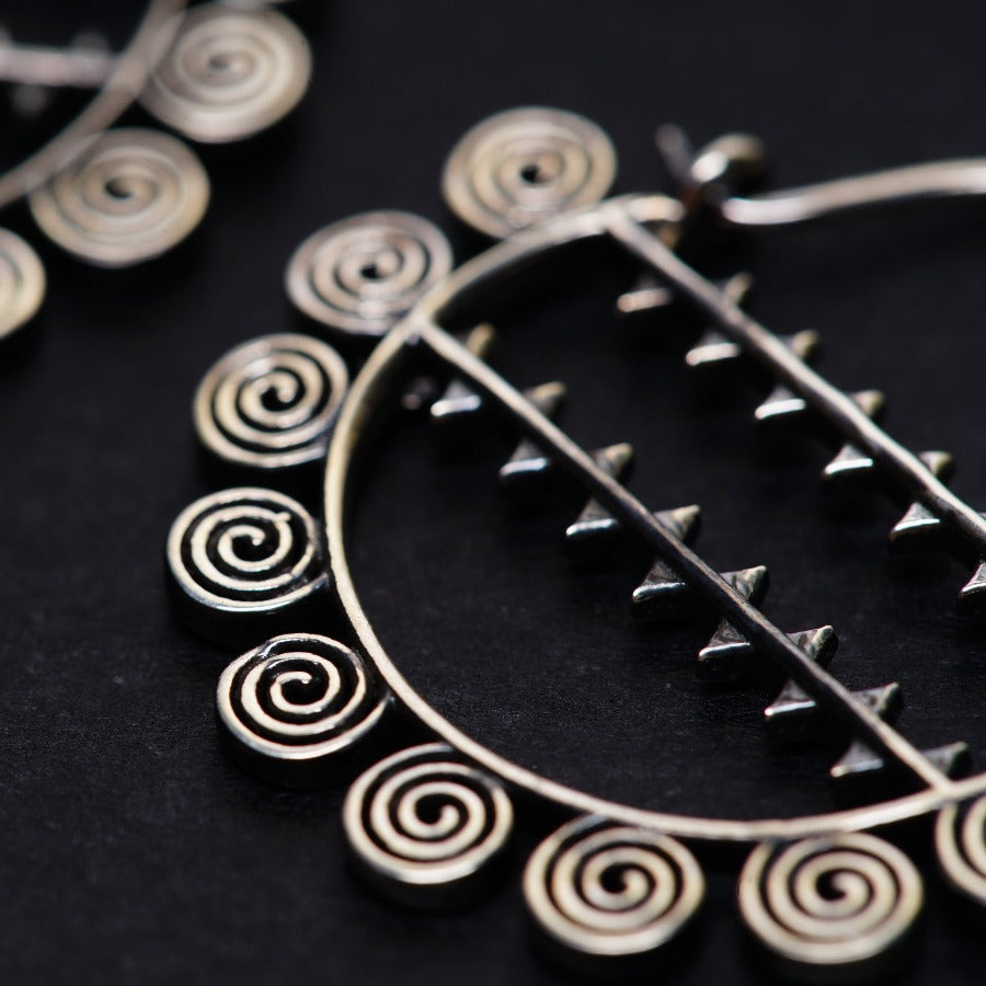 a close up of a pair of earrings on a table