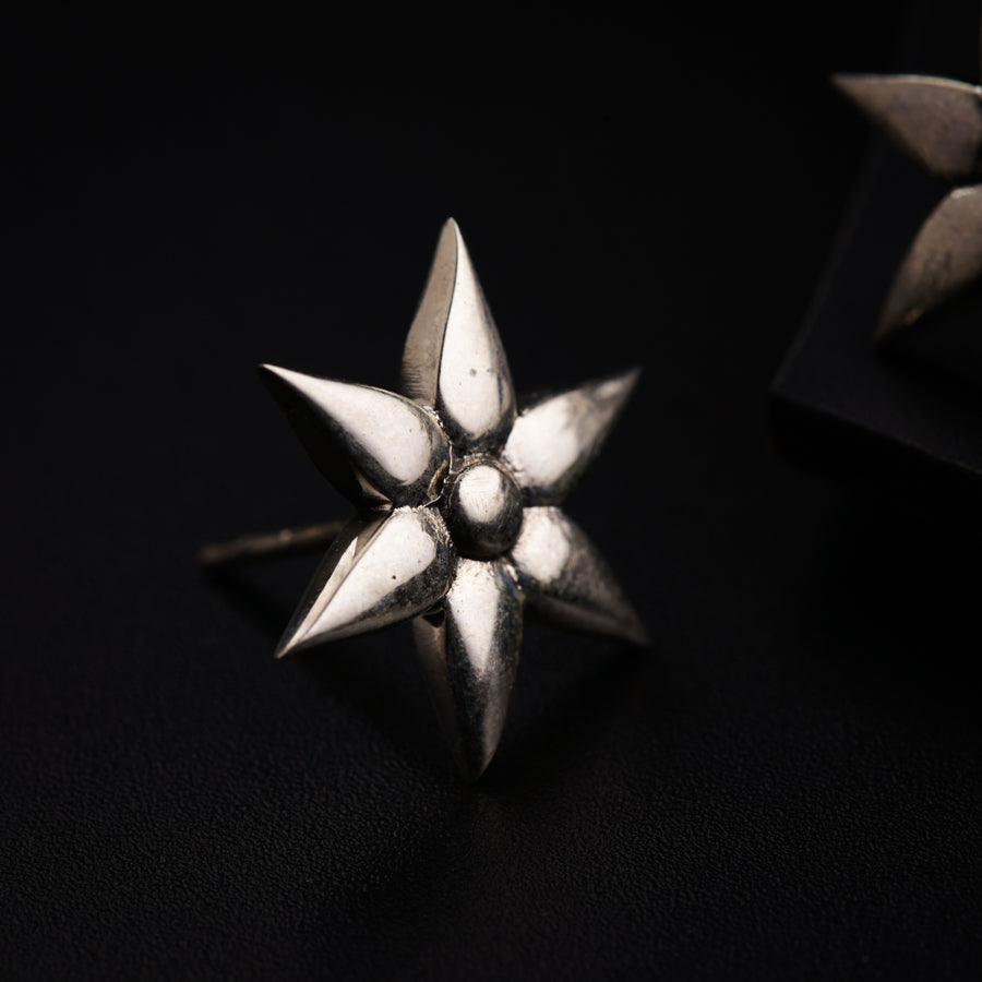 a close up of a metal object on a black surface