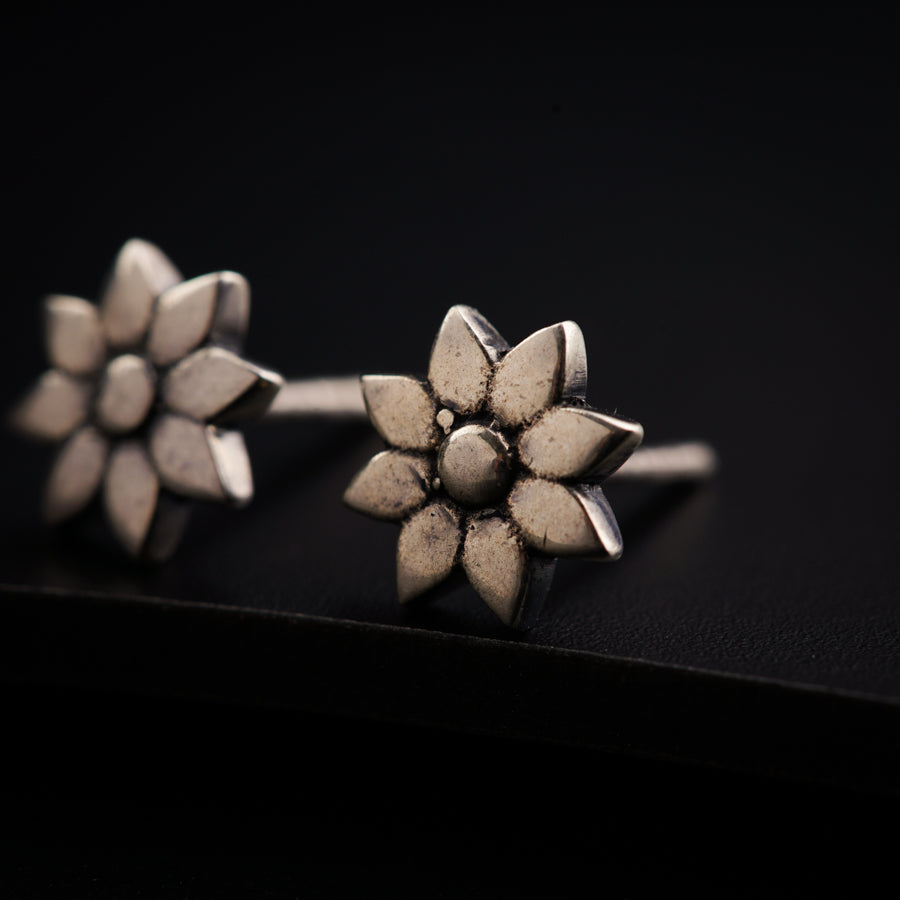 a close up of two silver rings on a black surface