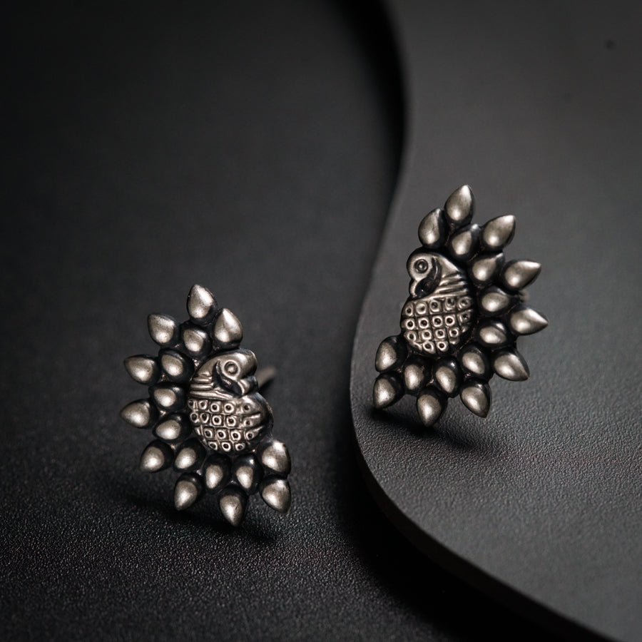 a pair of earrings sitting on top of a table