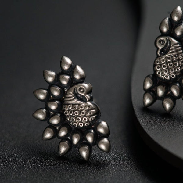 a pair of earrings sitting on top of a table