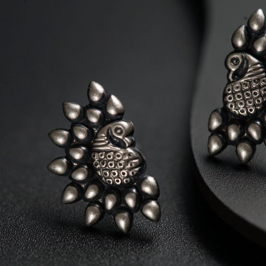 a pair of earrings sitting on top of a table