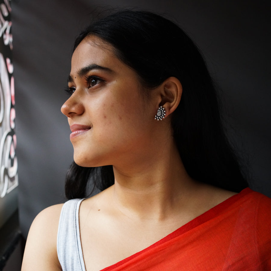 a woman in a red sari looking out a window
