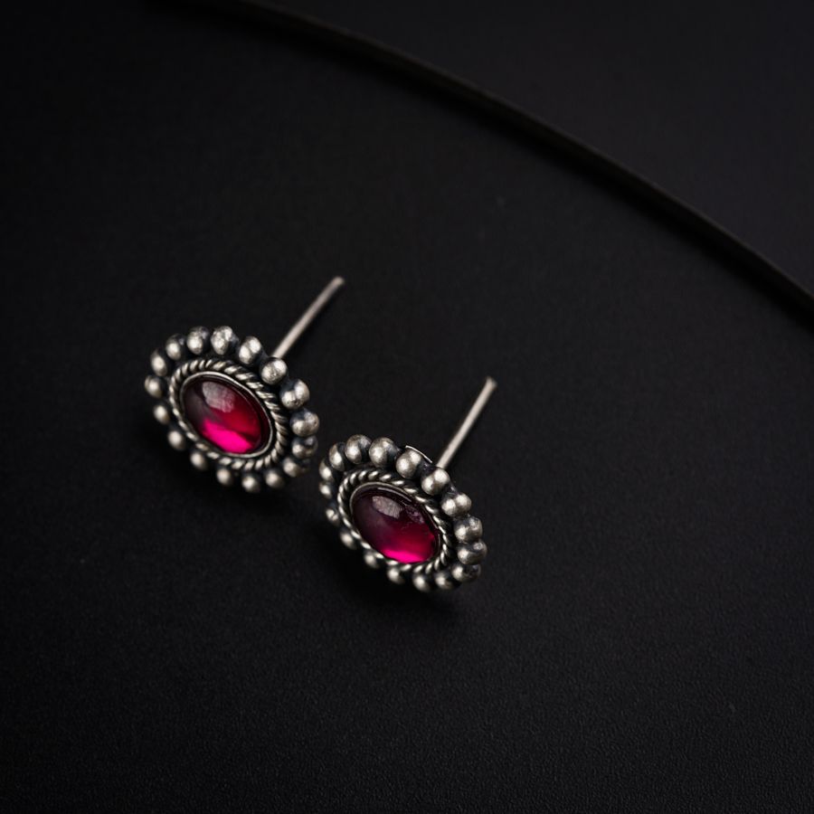 a pair of earrings on a black surface
