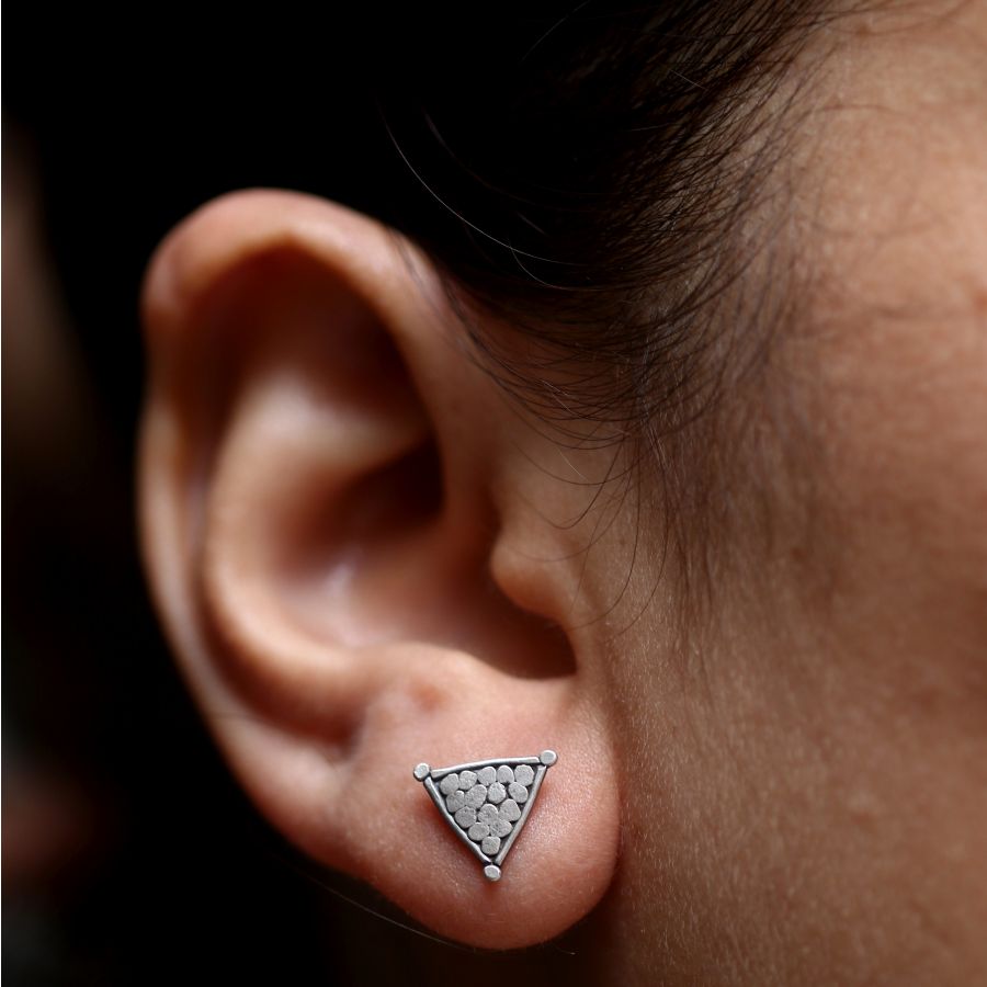 a close up of a person wearing a pair of ear piercings