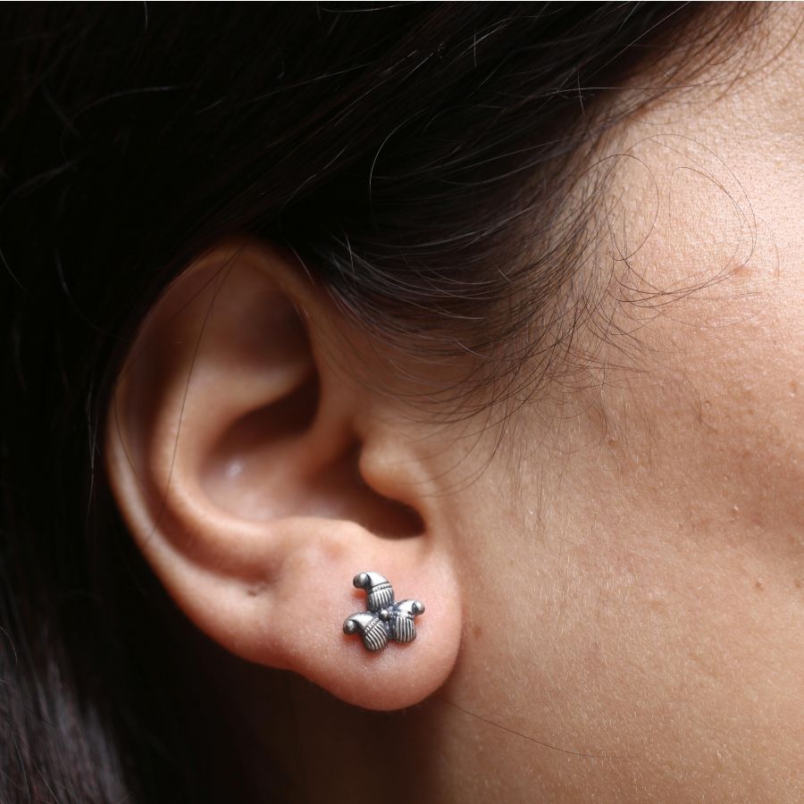 a close up of a person wearing a pair of ear piercings