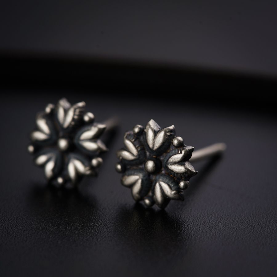 a pair of earrings sitting on top of a table