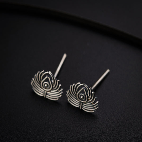 a pair of earrings sitting on top of a table