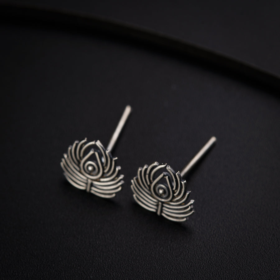 a pair of earrings sitting on top of a table