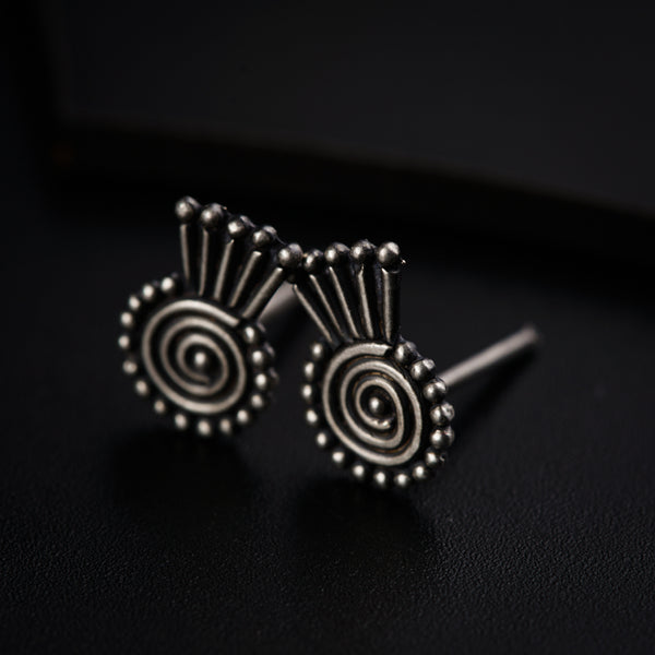 a pair of earrings sitting on top of a table