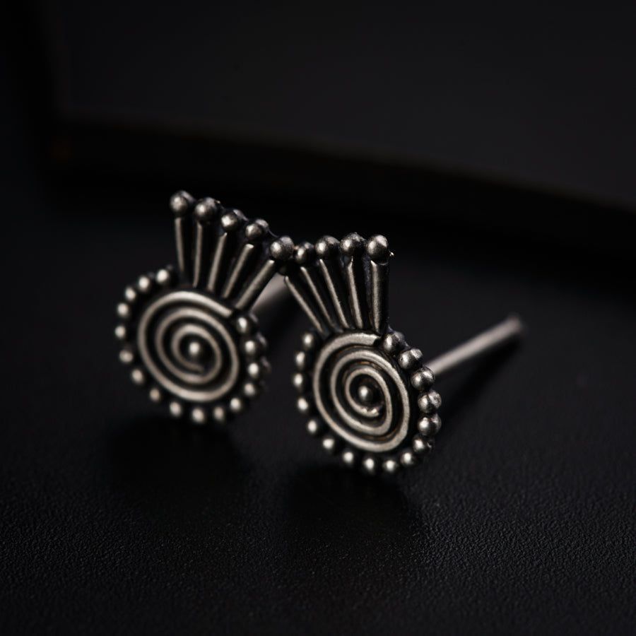 a pair of earrings sitting on top of a table