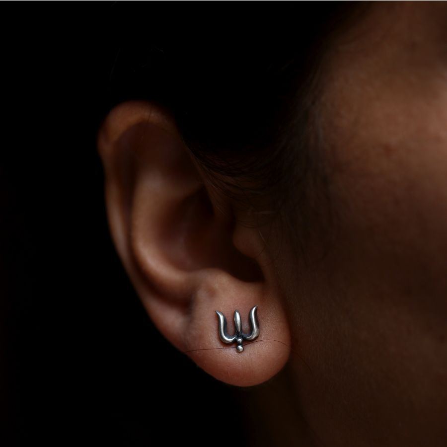 a close up of a person's ear with a piercing
